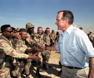 With the first Gulf War, President George H.W. Bush (above, in Saudi Arabia in late 1990) put into action what he would articulate in January 1989 as a New World Order, a geopolitical policy that called on the United States to punish aggression, expand democracy, and safeguard peace. Photograph: George H. W. Bush Presidential Library.