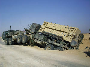 The author's Patriot missile launcher careened off the road, breaking a drive shaft. The crew guarded it until it was repaired, but then were able to drive it across the Kuwaiti border. (Courtesy of Carl Ciovacco)