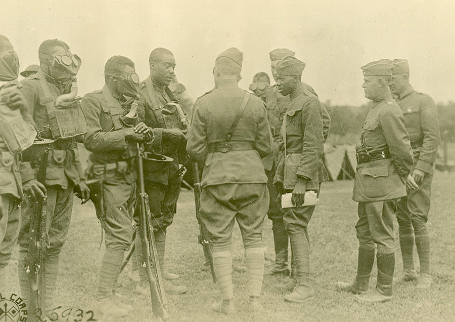 Members of the 366th Infantry Regiment, 92nd Division undergo training and have the fit of their masks inspected during a drill in France. Such measures could save their lives later when they were thrown into the Argonne offensive in October 1918. (U.S. Army Center of Military History)