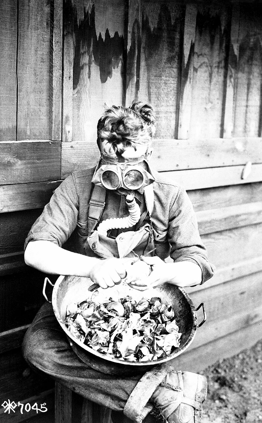 Though yet to see combat, a private in the 40th Division assigned onion peeling duty at Camp Kearny near San Diego, California, in March 1918 finds a way to put his mask and chemical warfare training to good use. (U.S. Army/National Archives)