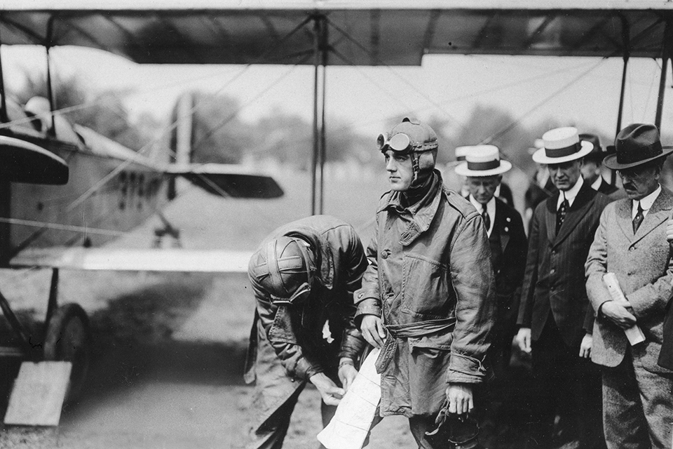 Major Fleet attaches an aerial map to the leg of Lt. George L. Boyle, who flew one of the the first mail planes from Washington to New York City. (Library of Congress)