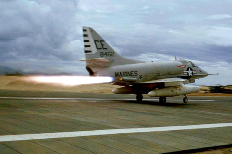 A Marine A-4E of VMA-225 gets a kick from jet-assisted takeoff (JATO) bottles to hasten ascent from the runway at Chu Lai. Externally mounted on the rear fuselage, the JATO bottles reduced the takeoff distance by half. (U.S. Marine Corps)