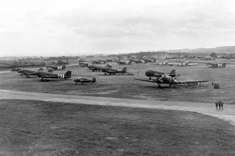 Decorated in their black and white invasion stripes, these C-47s, like hundreds of others at bases across southern England, await their cargo on the afternoon of June 5, 1944. (National Archives)