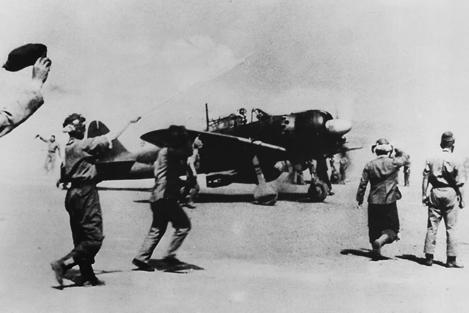 A pair of A6M5s with improvised bomb attachments prepare to depart from Mabalacat airfield on October 25, 1944, for the first official kamikaze mission. Nishizawa was among their escorts, claiming his last two victories. (U.S. Navy)