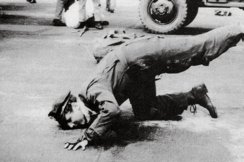 Joseph Weinstock, who had served as bombardier aboard the 324th deputy lead bomber during the raid, kisses the ground after returning to Bassingbourn, England, on April 25. It was Weinstock’s 35th—and the U.S. Eighth Air Force’s final—bombing mission of the war. (Lowell Getz/Dale Darling)