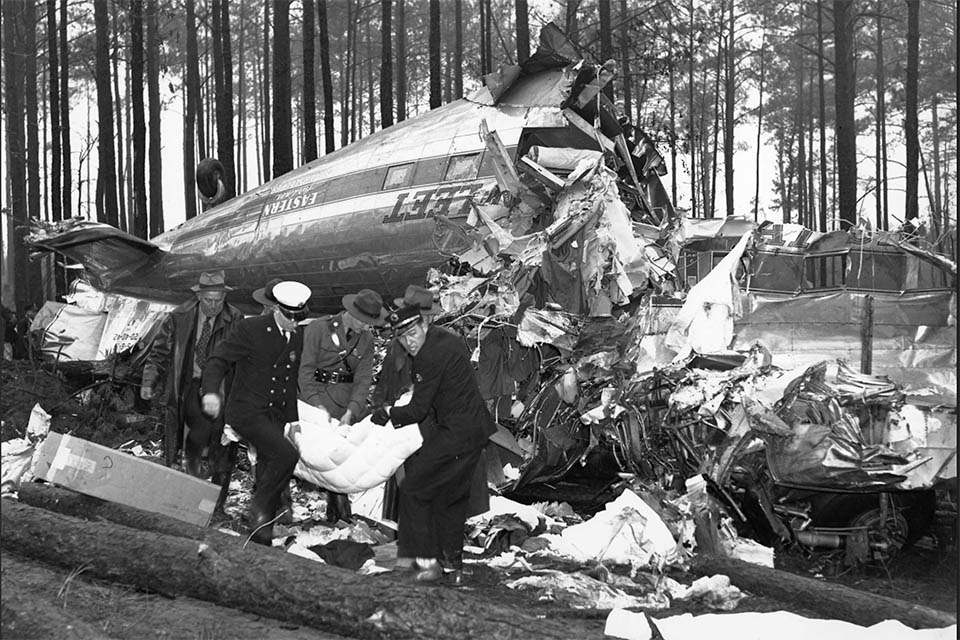 Rescue workers carry a badly injured Capt. Rickenbacker from the wreckage of an Eastern Airlines Mexico City Silver Sleeper which crashed near Morrow, GA. (Atlanta Journal/Constitution)