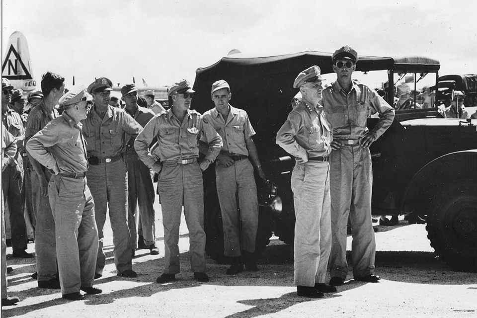 General Spaatz (center) and staff anxiously await the return of the crew of the B-29 ’Enola Gay' on Tinian, Northern Mariana Islands, August 6, 1945. (National Archives)
