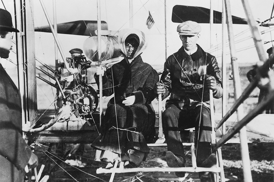 Orville looks on as Wilbur prepares to take off with sister Katherine on her first flight, near Pau on February 15, 1909. (Courtesy C.V. Glines)