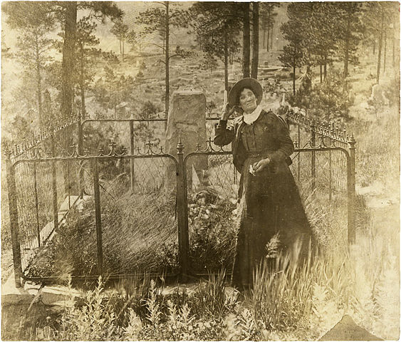 Calamity Jane visits the grave of old friend Bill Hickok at Deadwood's Mount Moriah Cemetery. She died the next month in 1903 at age 47, and is buried alongside Hickok's remains. 