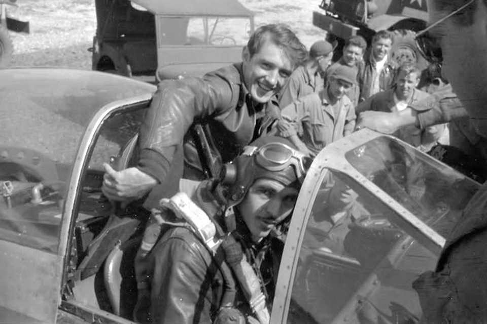 An exhausted Preddy is helped from his Mustang's cockpit after his six-victory mission on August 6, 1944. (352nd FG Association via Troy White)