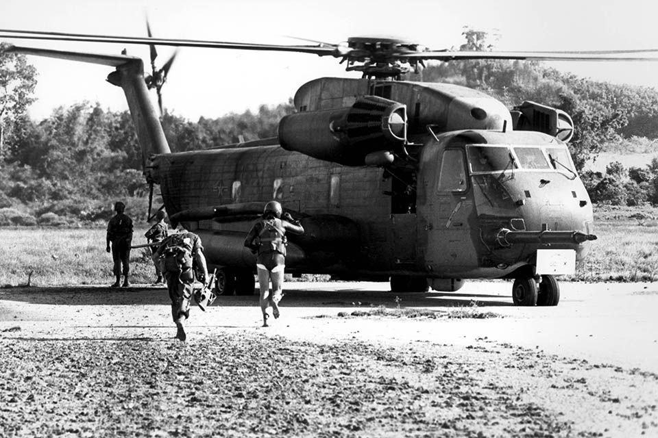 A Marine and an Air Force pararescueman (in wet suit) run for an HH-53 during the assault on Koh Tang Island to rescue the crew of merchant ship Mayaguez, May 15, 1975. (U.S. Air Force)