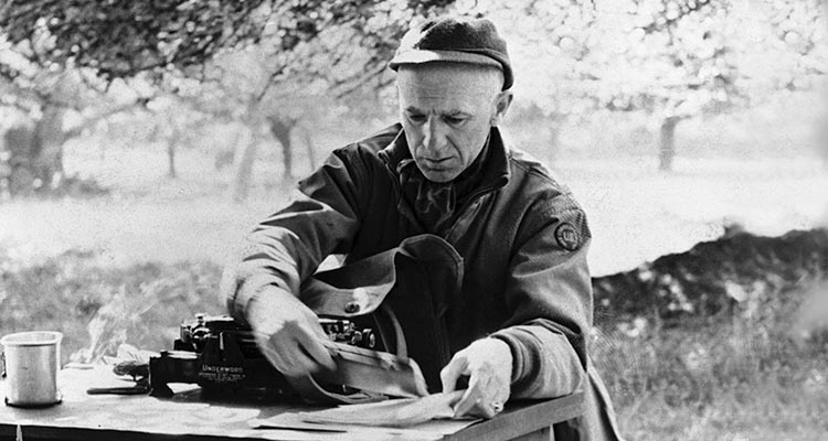 Correspondent Ernie Pyle, a favorite of GI and General alike, sorts out his 'office' in a French field.