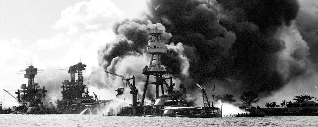 View looking up Battleship Row, after the Japanese attack. USS Arizona (right), to the left, USS Tennessee and the USS West Virginia. (U.S. Navy)