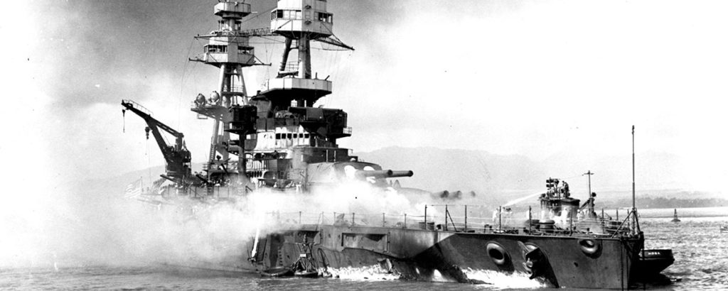 Beached and burning after being hit by Japanese bombs and torpedoes the Nevada would be rebuilt, modernized serving as a fire-support ship in the invasions of Normandy, Southern France, Iwo Jima, and Okinawa. (National Archives)