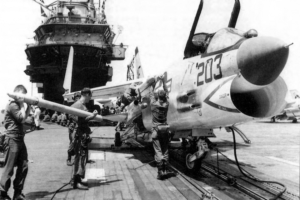 Zuni rockets are loaded Into the tubes of an F-8E from VF-53, aboard the USS Ticonderoga during the Tonkin Gulf Incident. (U.S. Navy)