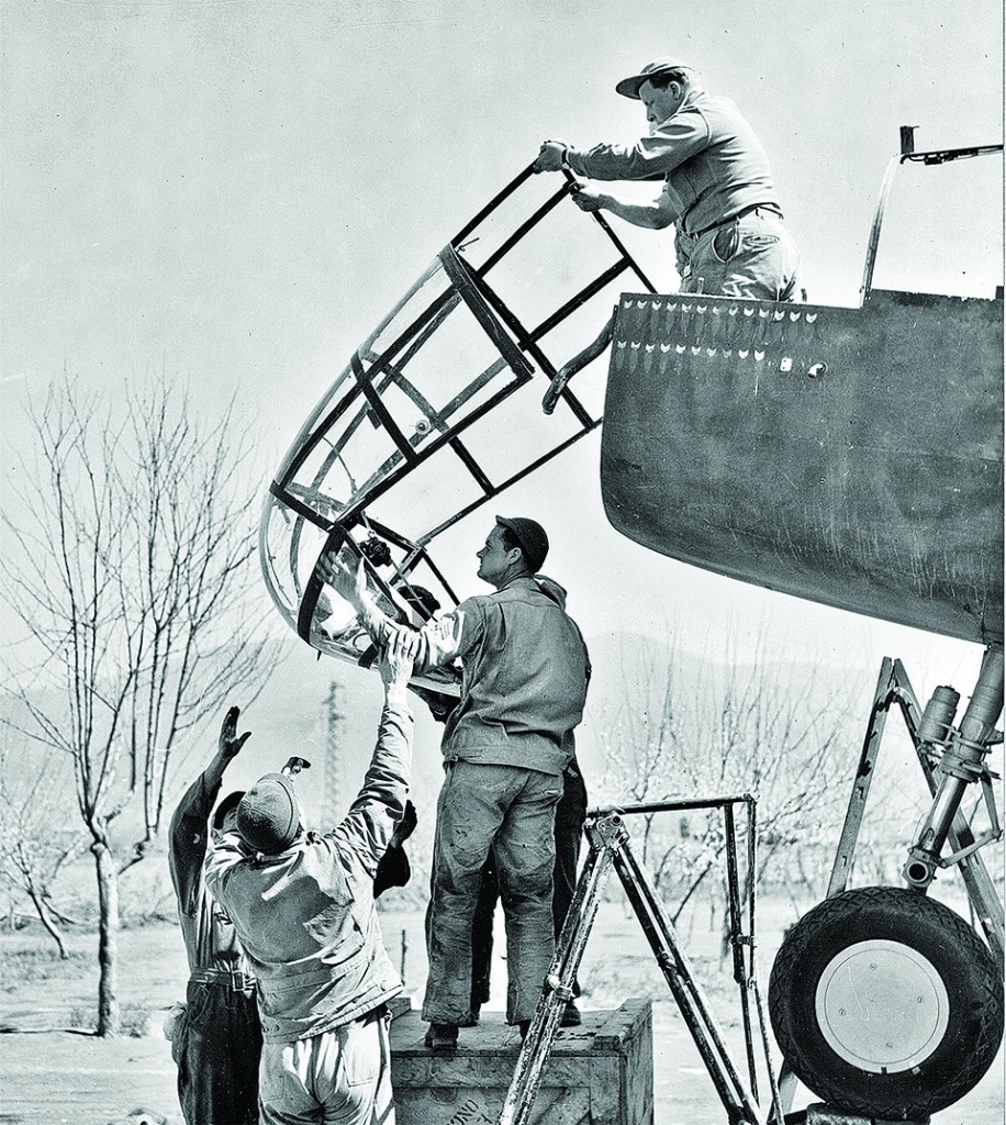 A repair crew hoists a fresh nose into position to replace one the eruption destroyed. (National Archives)