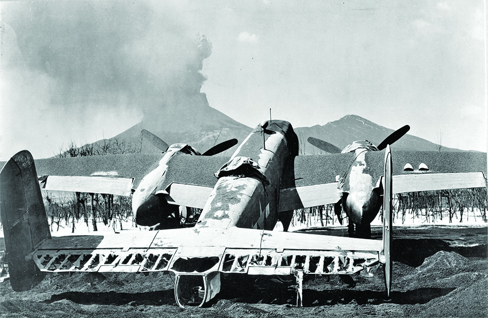 A B-25 whose fabric control surfaces have burned away stands useless. (National Archives)