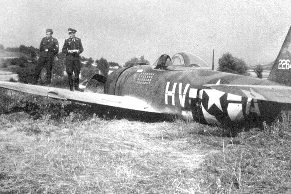 On July 20, 1944, while strafing targets over an enemy airfield, Gabreski flew too low and clipped his prop on the ground, resulting in a forced landing. Here Luftwaffe personnel examine his P-47 after he was taken prisoner. (National Archives)