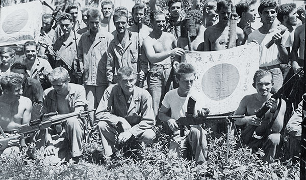 Two companies helped defend Midway Island from Japanese aerial attack in June, before Carlson (left, with Major Ralph Coyte) led the battalion on Makin and Guadalcanal. After their month-long patrol, the Raiders (above) were mentally and physically exhausted, but satisfied with their success in decimating Japanese forces across Guadalcanal.