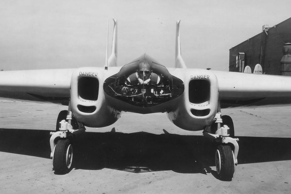 Crosby shows off the snug cockpit of the XP-79. It was thought a prone position would give the pilot the ability to withstand higher G-forces and raise his "blackout threshold." (USAF Flight Test Center Archives)