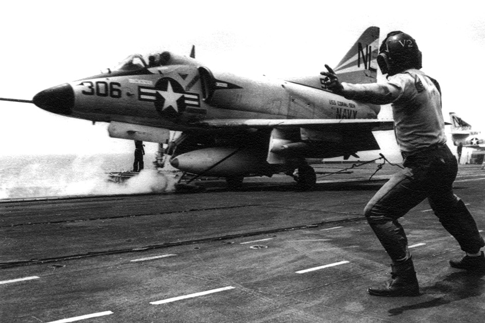 USS Coral Sea’s catapult officer gives the signal for a bomb-laden A-4C of VA-153 to launch off North Vietnam’s coast on March 24, 1965. (U.S. Navy)