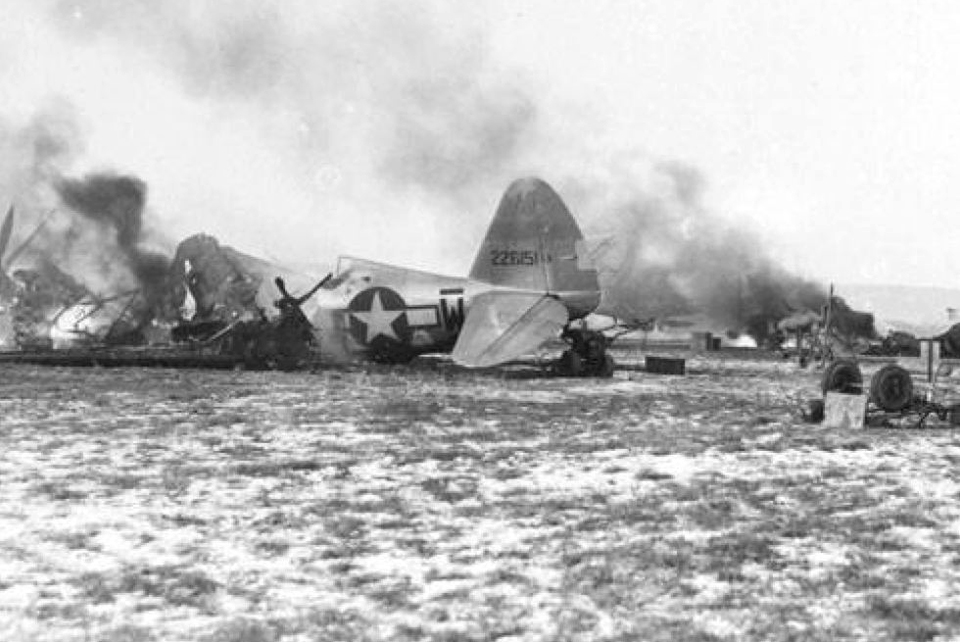 Republic P-47 Thunderbolts caught on the ground at the airfield near Metz burn after the German attack. (National Archives)