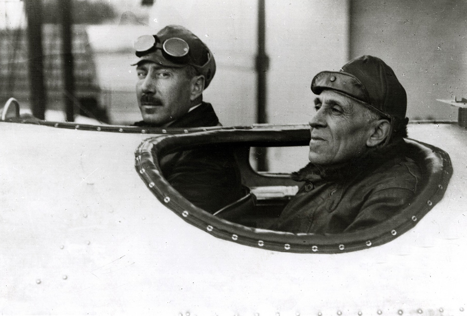 Pilot Commander Artur de Sacadura Cabral (left) and navigator Rear Adm. Carlos Viegas Gago Coutinho (right) sit in the cockpit of the floatplane "Lusitânia" at Lisbon Naval Base, shortly before their departure. (National Air and Space Museum)