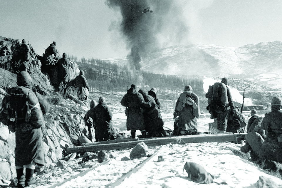 Marines watch a Corsair strike on the Hagaru perimeter. (Courtesy of Valor Studios)