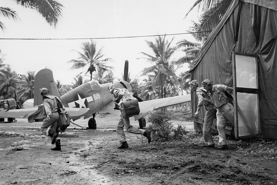 During a simulated scramble at Turtle Bay on September 11, 1943, Bill Case leads Rinabarger, Begert and Bourgeois to their F4U-1s. (National Archives)