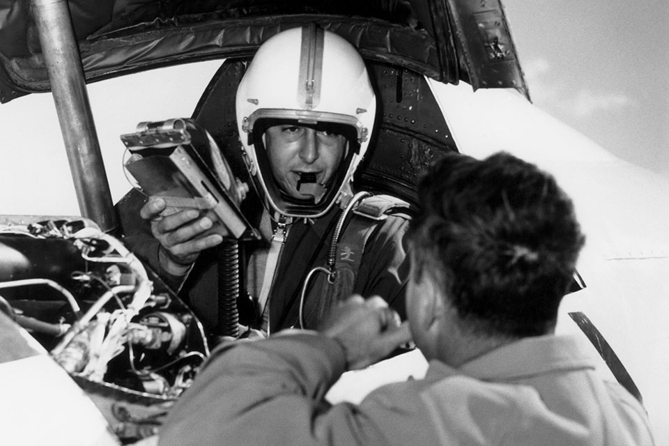 The test pilot hands over his logbook shortly after his historic flight. (NASA photo)