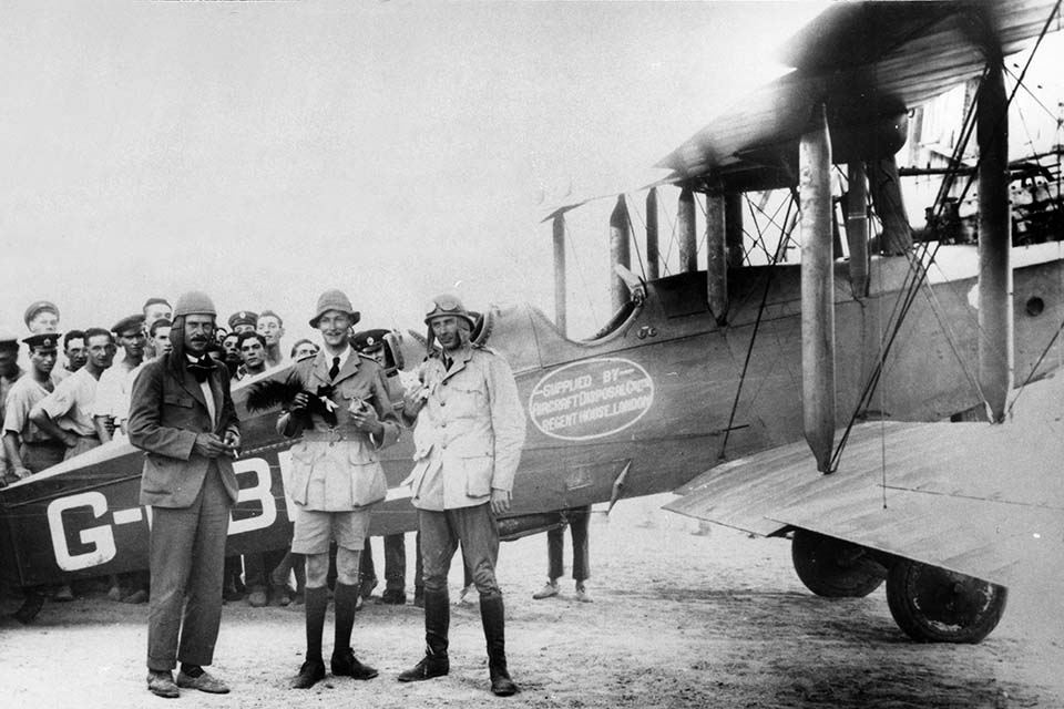 From left, pilot Norman Macmillian, William T. Blake and photographer Geoffrey Malins stand beside their modified Airco D.H.9 at RAF Shaibah. (RAF Museum, Hendon)