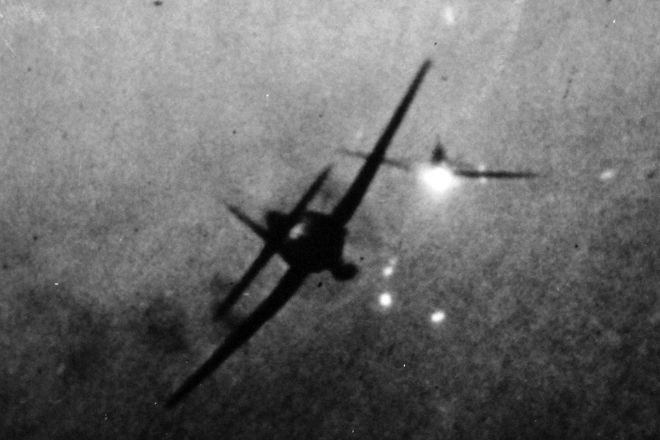 In this gun camera still from another Hellcat, a squadron mate slides in to take the shot at a Japanese Mitsubishi A6M Zero. (National Archives)
