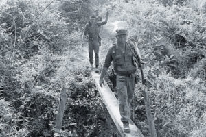 Marines cross through enemy territory near Binh Thai, about 9 miles from the Da Nang air base on April 22, 1965.