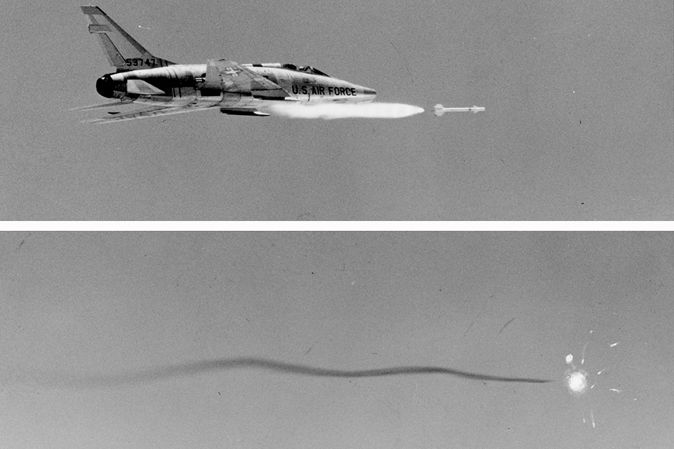 An F-100 fires a missile, which takes a winding path to its target. (National Archives)