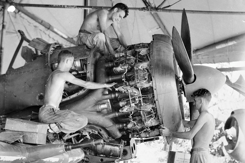 Ground crewmen work on a “Boomer” at Piva airfield on Bougainville in January 1945. (Australian War Memorial)