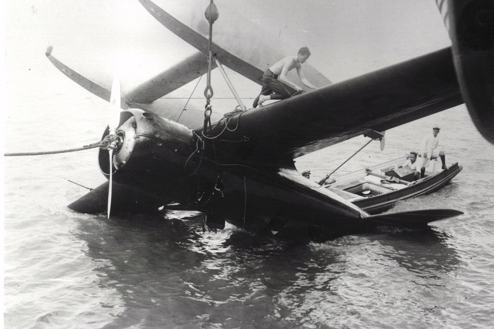 Hoisted aboard the British carrier Hermes, the Sirius flipped over upon its return to the Yangtze River. (National Air and Space Museum)