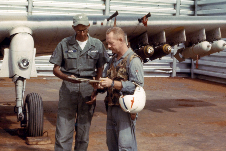 USAF Maj. Bernard F. Fisher, (right) talks maintenance with his crew chief, TSgt. Rodney L. J. Souza. Fisher rescued a downed colleague in a dramatic landing with his Skyraider. (USAF)