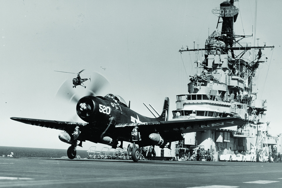 A Skyraider takes off from USS Valley Forge in March 1951 while a Sikorsky HO3S-1 rescue chopper stands by. (National Archives)