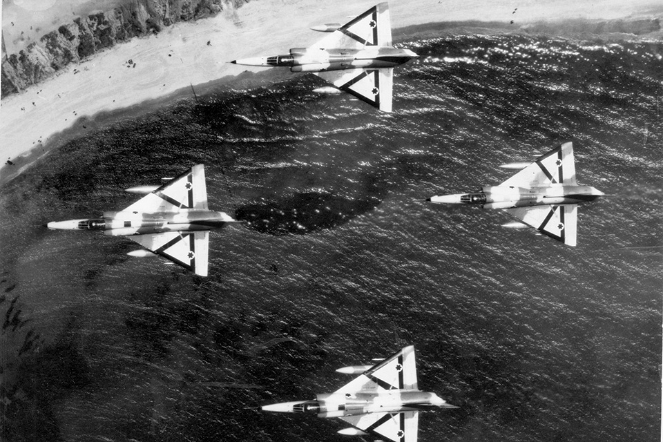 A quartet of Kfir C1s display triangular black and orange recognition markings. The early-model Kfirs, which entered service in 1975, had a mini-canard to improve stability. (Israeli Air Force)