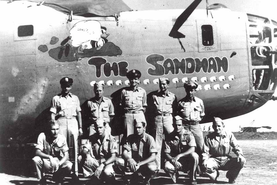 B-24D crew of "The Sandman”: (standing, from left) Major Robert W. Sternfels, pilot; copilot Barney Jackson; navigator Tony Flesch; bombardier Dave Polaschek; flight engineer Bill Stout; (kneeling, from left) radioman Frank Just and gunners Harry Rifkin, N. Petri, Merle Boland and Raymond Stewart. This photo was taken after the Ploesti raid. Note balloon cable scar to the left of crew on fuselage. (Courtesy of Robert W. Sternfels)
