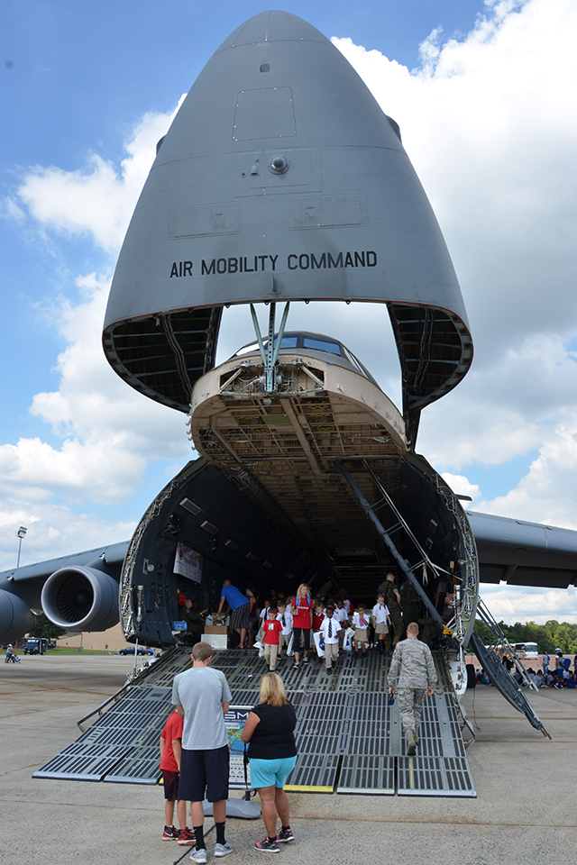 Schoolchildren emerge from the gaping maw of an Air Mobility Command Lockheed C-5 Galaxy. (Carl von Wodtke)