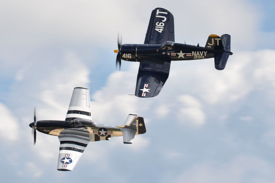 Scott “Scooter” Yoak pilots his North American P-51D “Quick Silver” in formation with Jim Tobul’s Vought F4U-4 Corsair “Korean War Hero” during a Class of ’45 performance. (Carl von Wodtke)