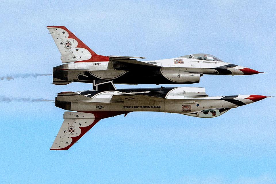 Two Thunderbird F-16s perform a reflection pass at Andrews Air Force Base. (U.S. Air Force)