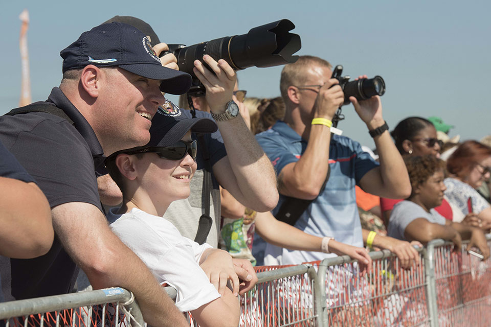 Spectators watch and photograph the action on the flight line during the Andrews airshow. (U.S. Air Force)