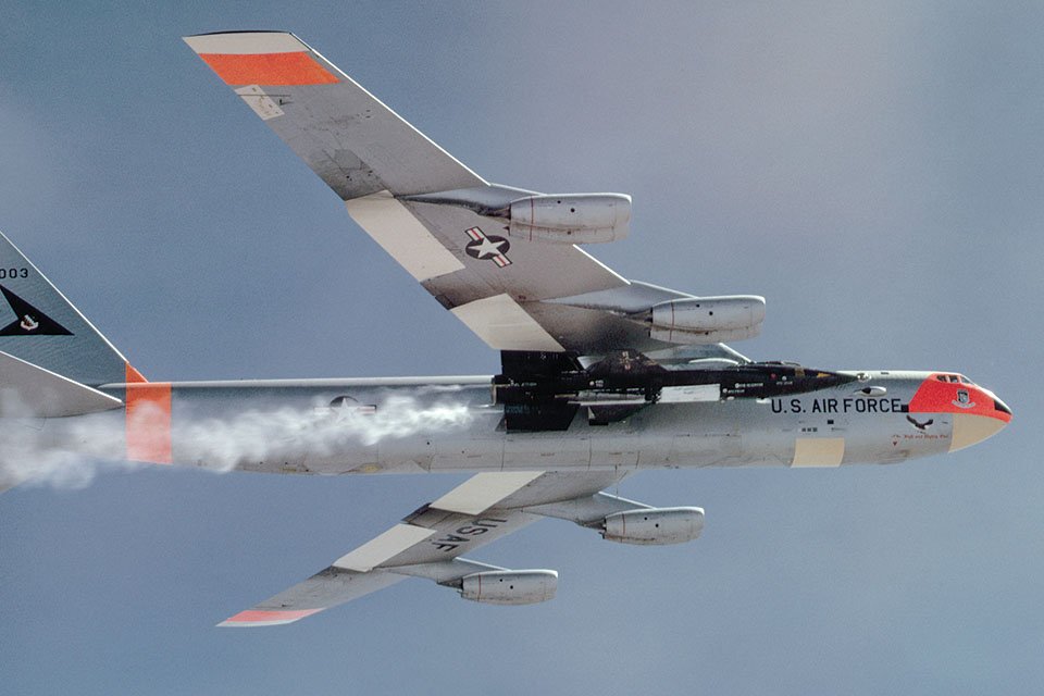 B-52A no. 52-003 carries a North American X-15 rocket plane to launch altitude over Edwards Air Force Base. (Dean Conger/Getty Images)