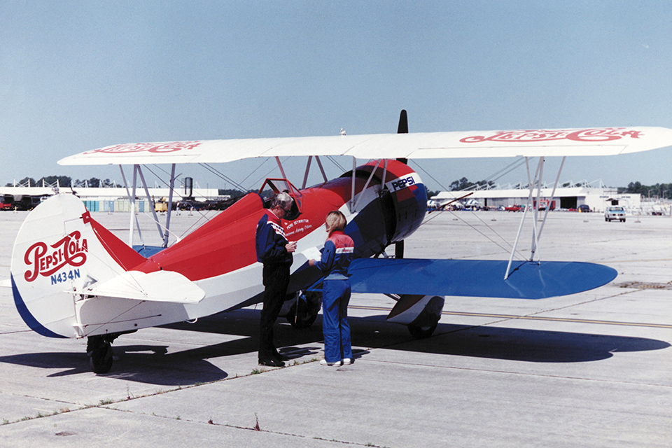 Pilots Steve Oliver and Suzanne Asbury-Oliver do some preflight planning next to PepsiCo’s Travel Air D4D. (East Carolina University Collections)