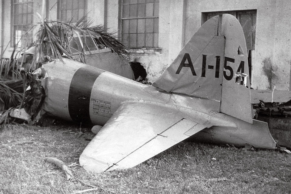 Hirano crashed into Fort Kamehameha's ordnance shop. The Zero's tail, still displaying carrier "Akagi" markings, was largely intact. (National Archives)