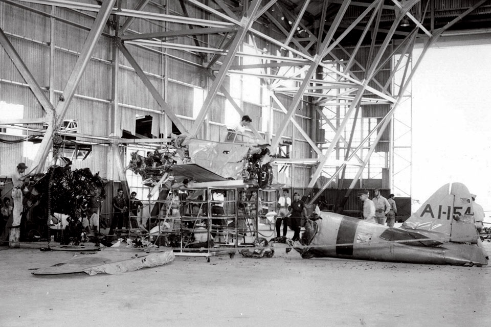 Workers at the Hawaiian Air Depot hangar begin to assemble parts of the wrecked fighter prior to their examination and evaluation. (National Archives)