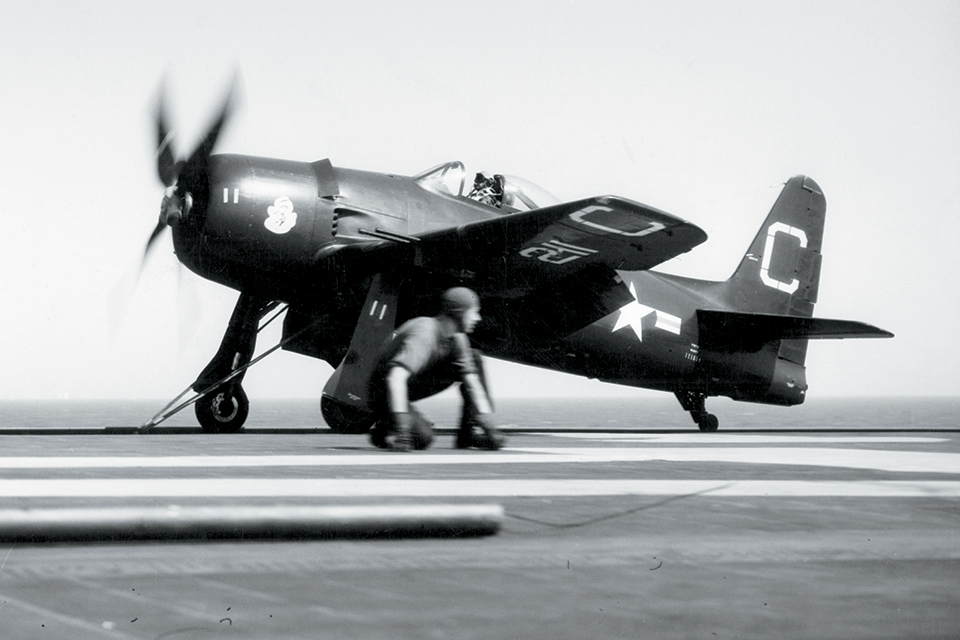 A deck worker takes his position near the wing of an F8F-2 of VF-62 while the pilot prepares for a catapult launch from the carrier Coral Sea on September 14, 1948. (National Archives)