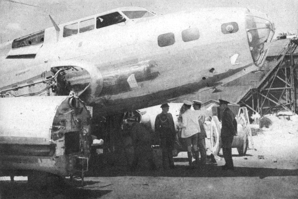 Japanese officials examine the remains of a B-17D at Clark Field in the Philippines. (National Archives)